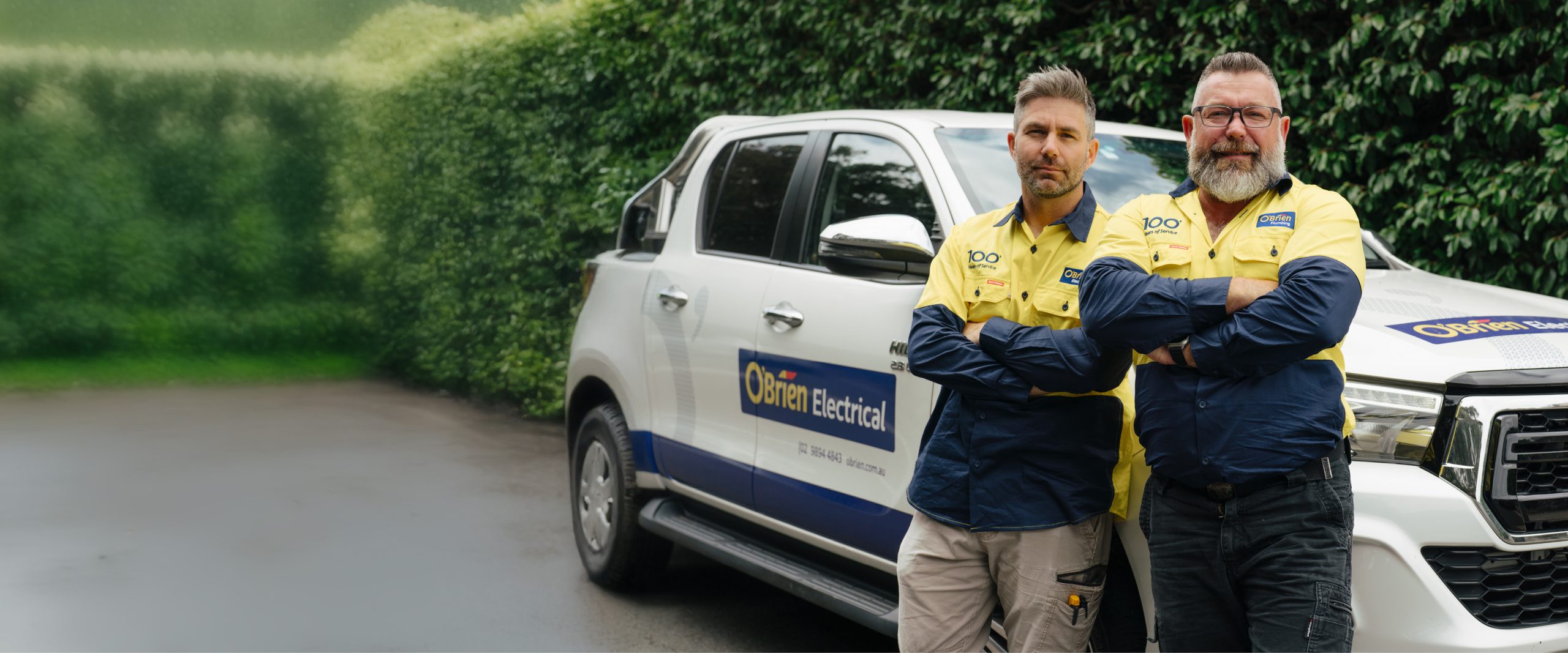 O'Brien electrical technicians beside a service vehicle