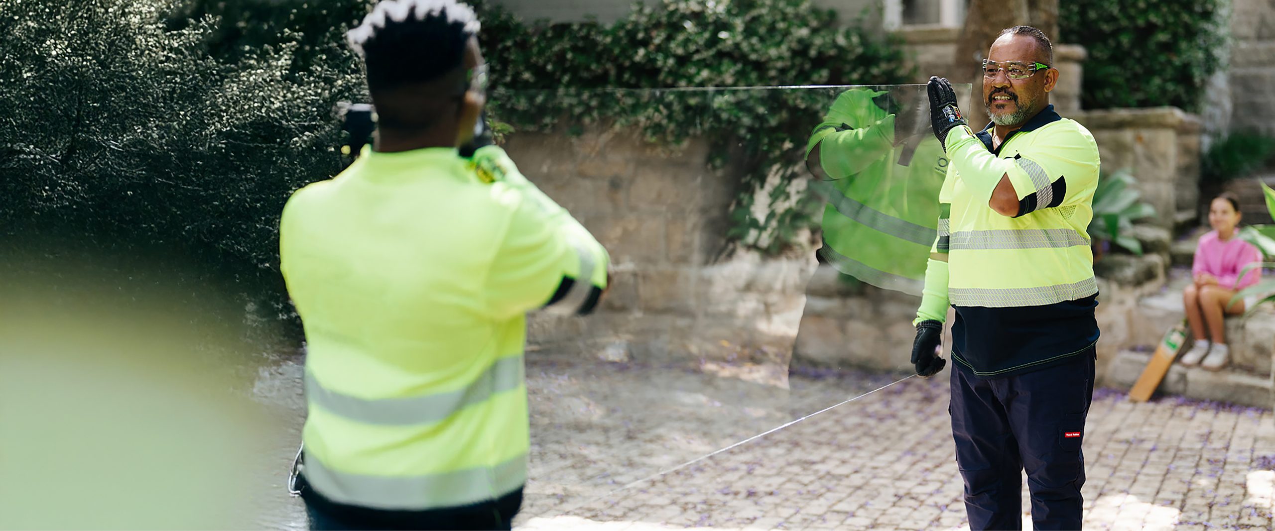 O'Brien glaziers carrying a glass panel